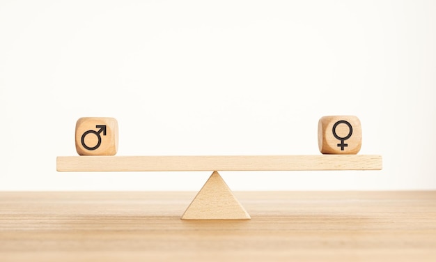 Gender equality concept Wooden block with gender icon on a seesaw Copy space