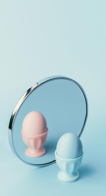 Photo gender identity problem concept the egg is blue in front of the mirror in the reflection it is pink