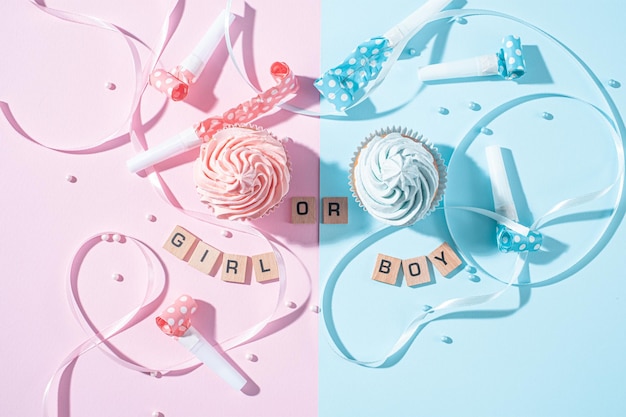 Gender party boy or girl two cupcakes with blue and pink cream celebration concept when the gender of the child becomes known