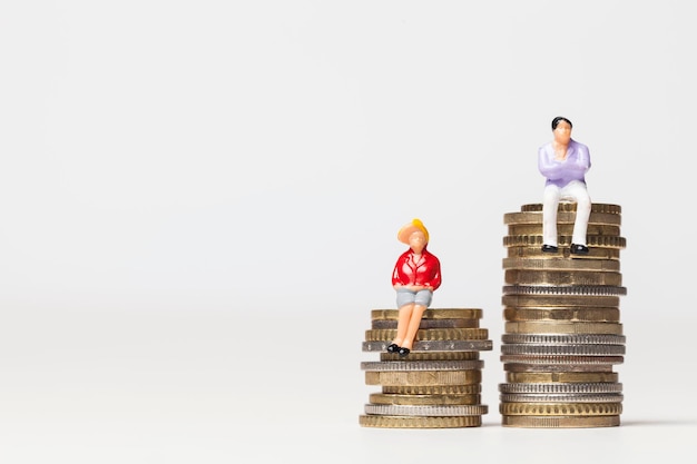 Gender pay equality concept man and woman on a stack of coins