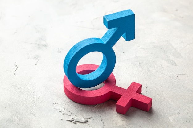 Gender symbols of man and woman on a gray background.