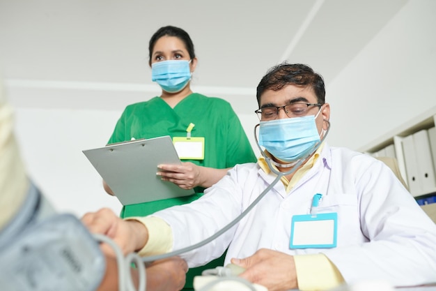 General Practitioner Examining Patient