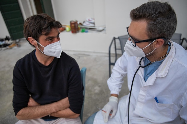 General practitioner visits the patient at his home home visit wearing face masks