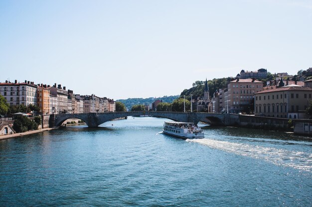 General view of ChalonsurSaone French city in SaoneetLoire department Boat sailing through Saone River