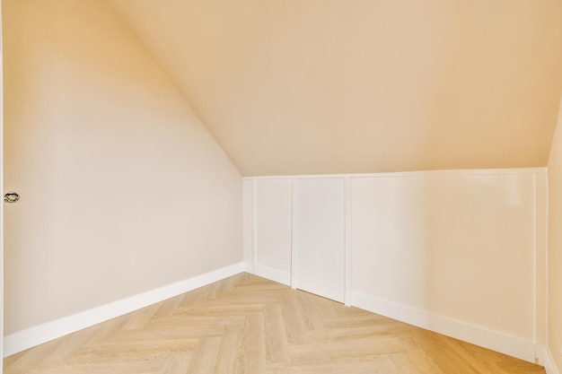 General view of an empty bright room in beige design and a parquet floor in a modern house