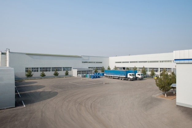 General view of the factory with trucks. a truck in the parking lot of the plant