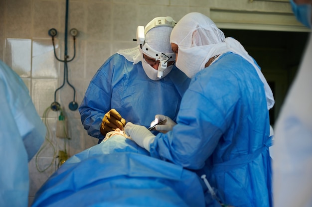 General view of the surgeons in the operating room