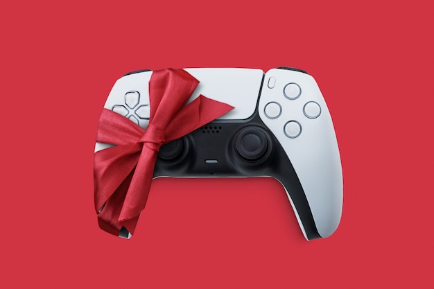 Next generation white game controller giftwrapped with ribbon gift from Santa Claus at Christmas