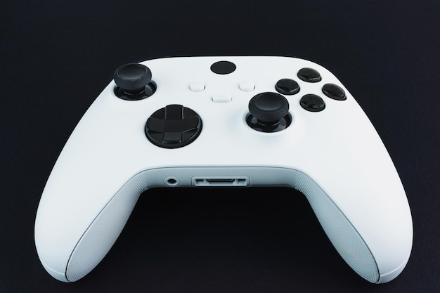 Next generation white game controller isolated on black background.