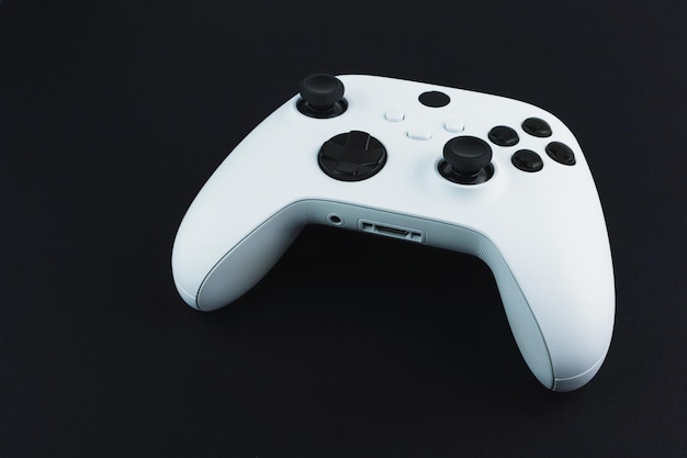 Next generation white game controller isolated on black background.