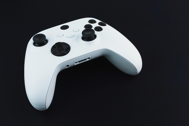 Next generation white game controller isolated on black background.