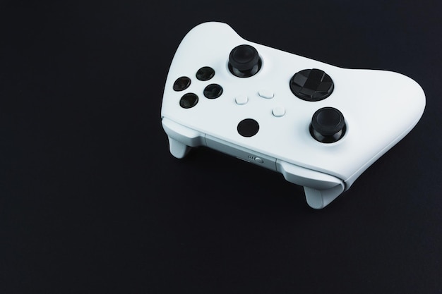 Next generation white game controller isolated on black background.