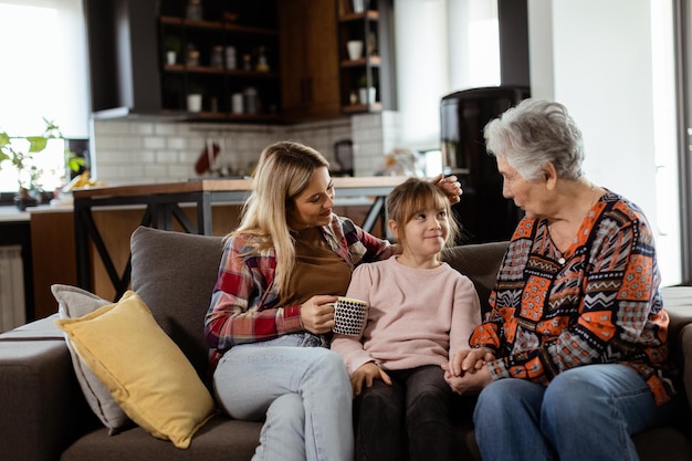 Generational bonding grandmother daughter and grandchild sharing stories on a cozy afternoon