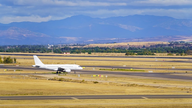 Generic plane rolling along the slope next to some high mountains Madrid Spain