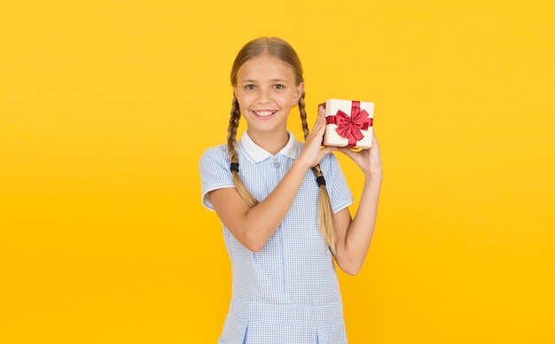 Generosity concept Holiday celebration Girl received gift Tidy adorable pupil open gift box Educational program for gifted kids Happy birthday Knowledge day Schoolgirl giving gift to you