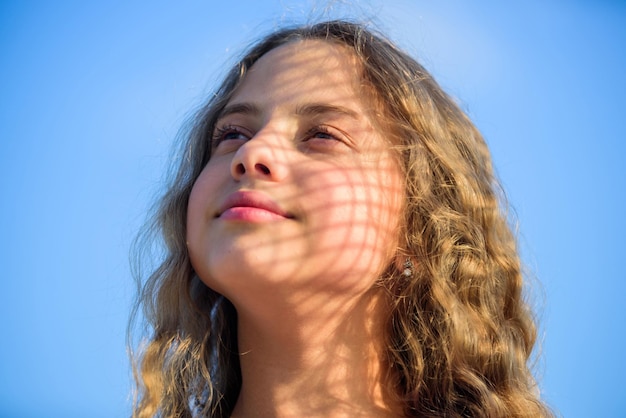 Geniet van het weekend gelukkige jeugd perfecte gezonde huid jeugd is briljant zomervakantie geniet van goed weer kind mode mooi kind buiten natuurlijke schoonheid klein meisje lang krullend haar