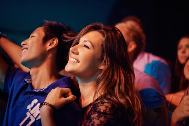 Genieten van de show Een jong stel dat samen geniet van een optreden op een festival