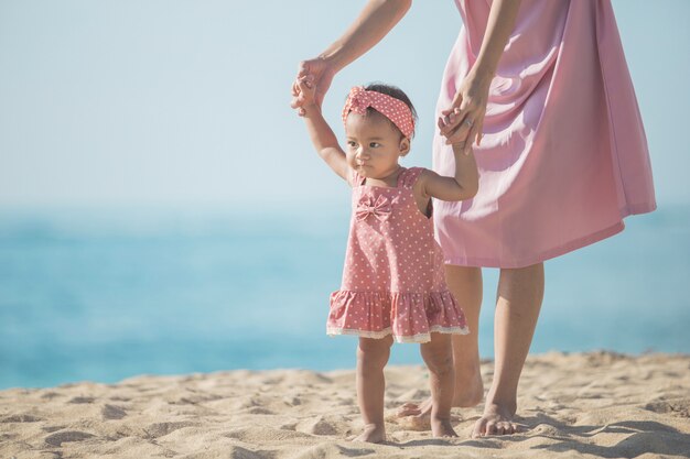 Genieten van haar eerste stap op het zand