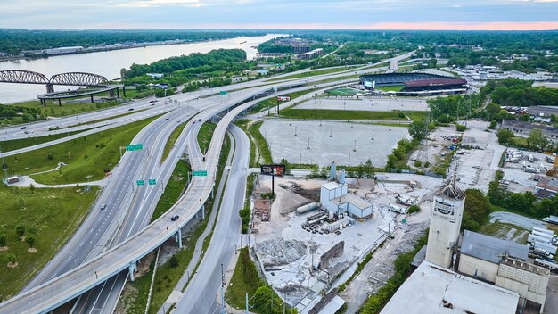 Gentle dawn nearly empty highway roads suspended in large US city with Ohio River aerial