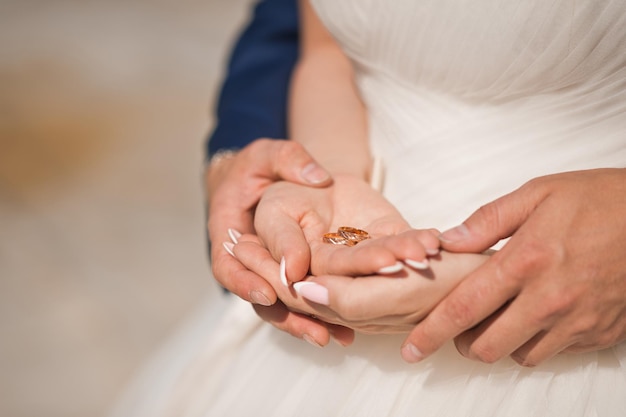 Gentle embrace of the hands of the newlyweds 3938