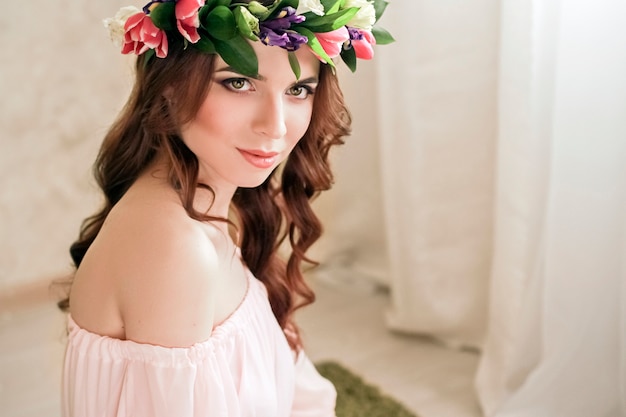 Gentle romantic appearance of girl with a wreath