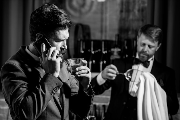 Gentlemans beverage Whiskey in glass Bartending concept Barman at counter Hipster in bar