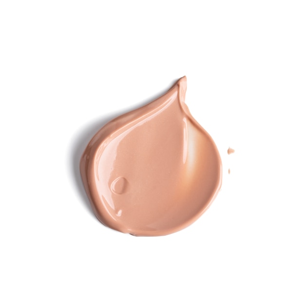 Gently beige smear of makeup cream foundation isolated on white background. Texture of liquid foundation.