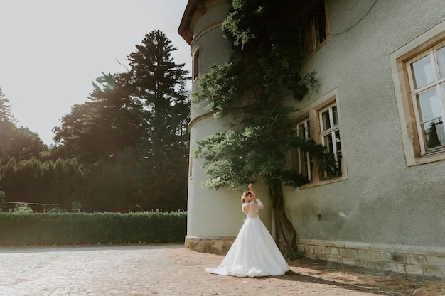 gently bride in lace dress backgroung wall in garden