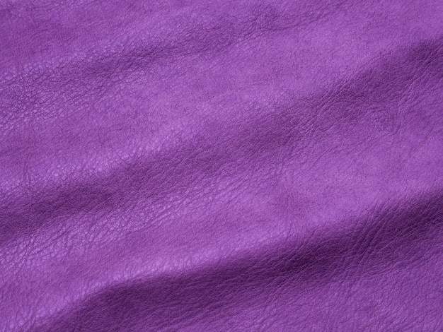 Genuine purple cattle leather texture background Macro photo
