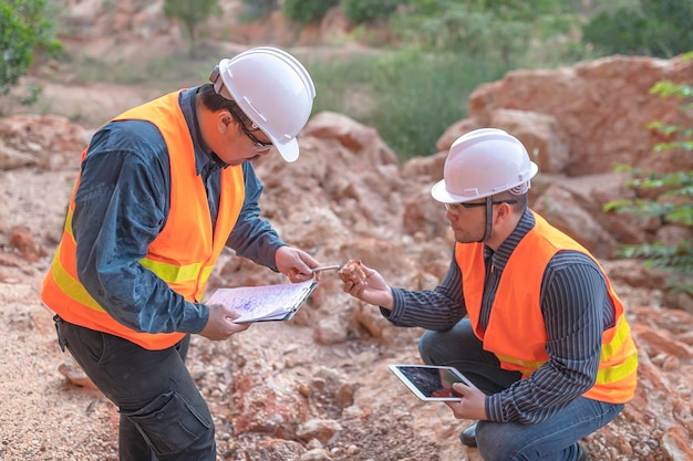 Photo geologist surveying mineexplorers collect soil samples to look for minerals