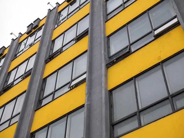 Geometric facade of building in the colors 2021 Yellow and gray wall