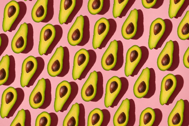 The geometric pattern is a lot of sliced avocado on a pink background.