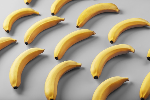 Geometric pattern of yellow bananas on a gray background in the Fashionable colors