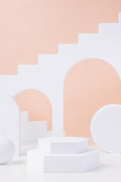 Geometric pedestal block on white table and pastel peach background.mockup for display product