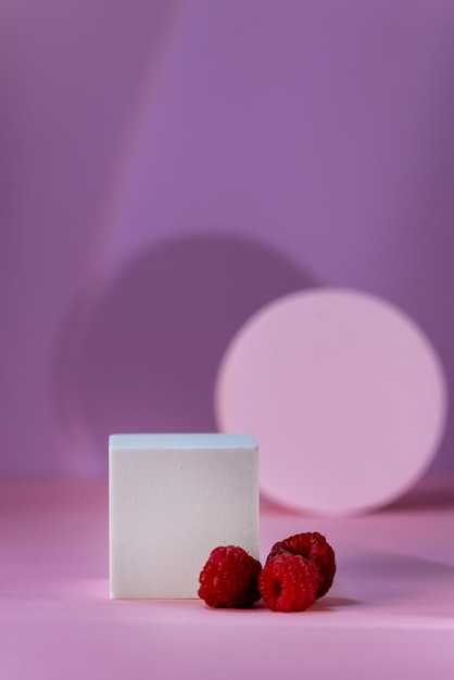 Geometric Podium for Product Demonstration and Raspberry on Pink Background with Shadow