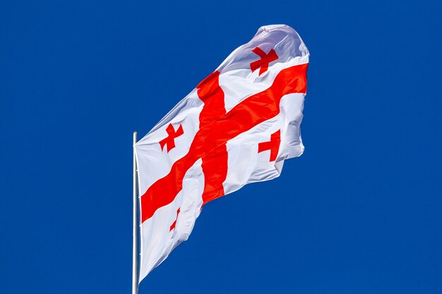 Georgia national flag waving in the wind on a blue sky