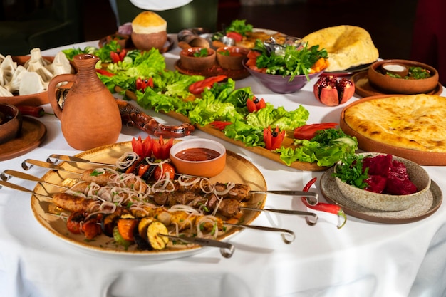 Georgian cuisine A large laid table of different dishes for the whole family on a day off Kebab Lula Lavash Suluguni cheese Khachipuri Khinkali background image