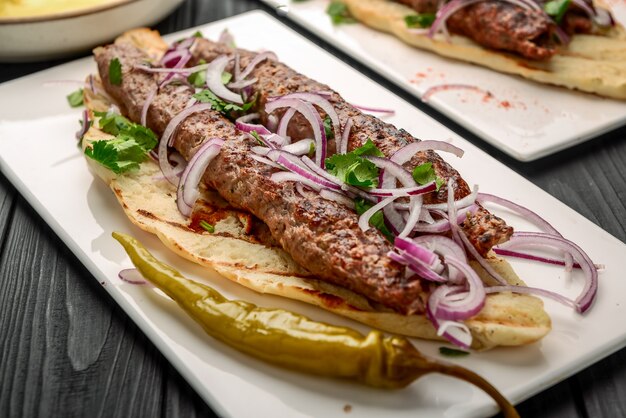 Georgian cuisine - lulia kebab, with grilled onions, traditional Georgian cuisine, on bread