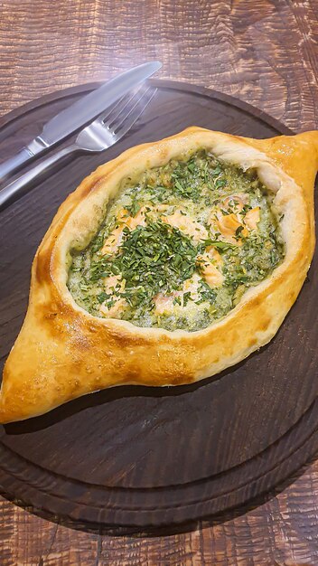 Georgian pastry dish Pie with red fish and spinach