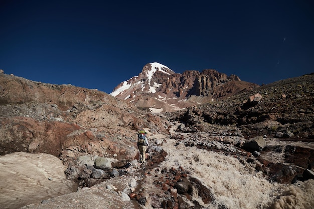 Gergeti glacier waterfall nature of caucasian mountains road to\
the base camp in kazbek georgia mount kazbek alpinist\
expedition