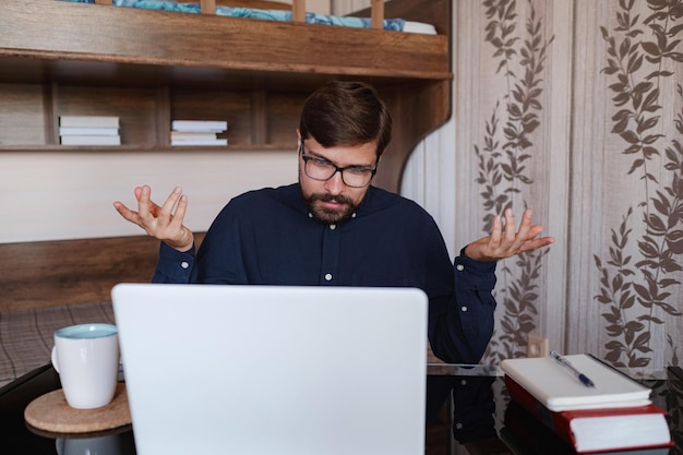 Gerichte man zit aan bureau en kijkt naar webinar videocursus