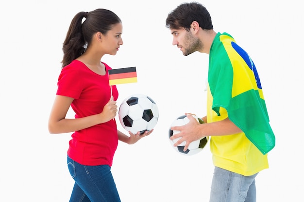 German and brazilian football fan facing off