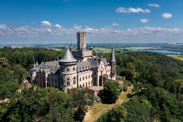 German castle Marienburg immersed in the greenery of the forest not far from Hannover Aerial view of a medieval romantic castle