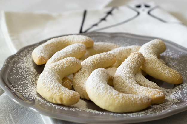 German Christmas pastries vanilla crescent vanillekipferl on grey plate