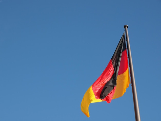 German flag over blue sky