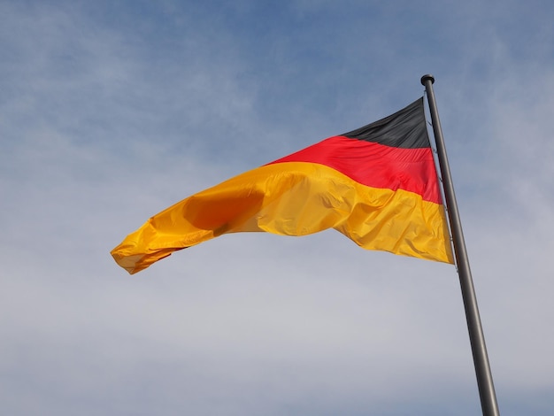 German flag over blue sky