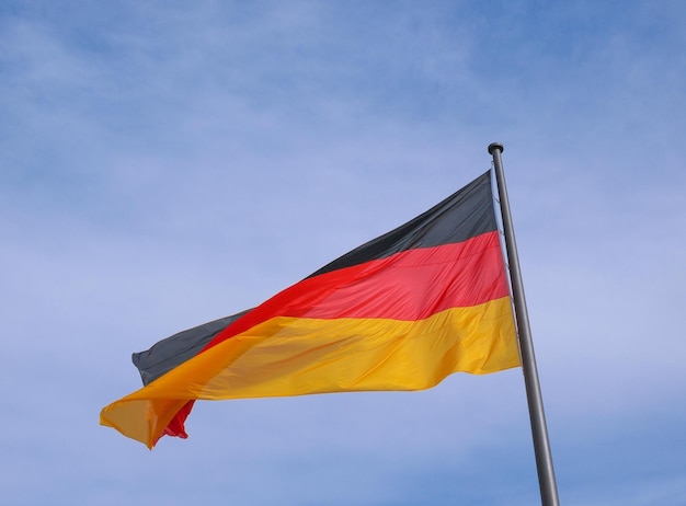 German flag over blue sky