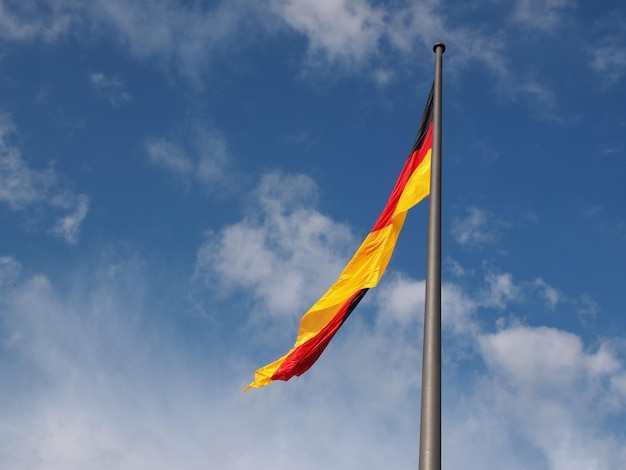 German flag over blue sky