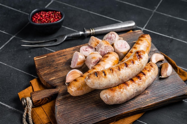 German grilled Bratwurst pork meat sausages on a wooden board Wooden background Top view