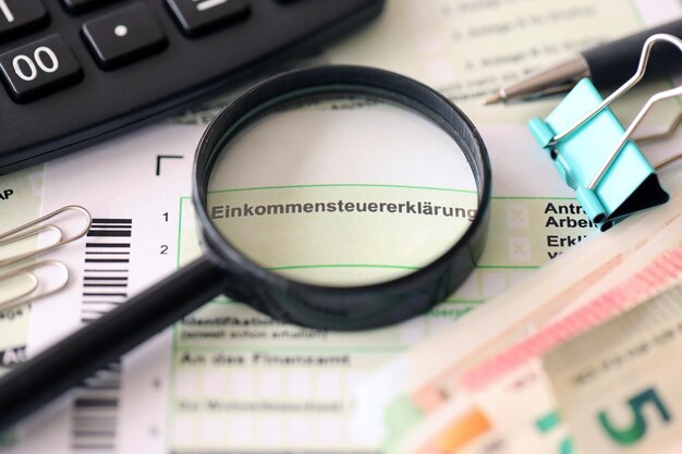 German income tax return form with pen and european euro money
bills lies on accountant table close up taxpayers in germany using
euro currency to pay taxes